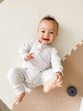 White ribbed footless sleepsuit with two buttons at top